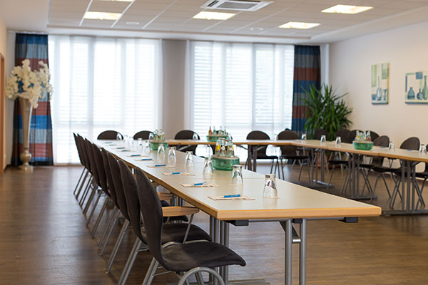 Prepared seminar room with u-shaped seating in the conference hotel Spessart in Lower Franconia