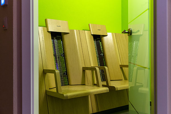 Infrared room with two wooden benches in the wellness area of the hotel in Karlstadt