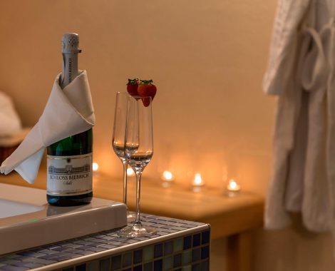 Sparkling wine with two champagne glasses on the edge of a bathtub in the wellness area of the hotel in Karlstadt